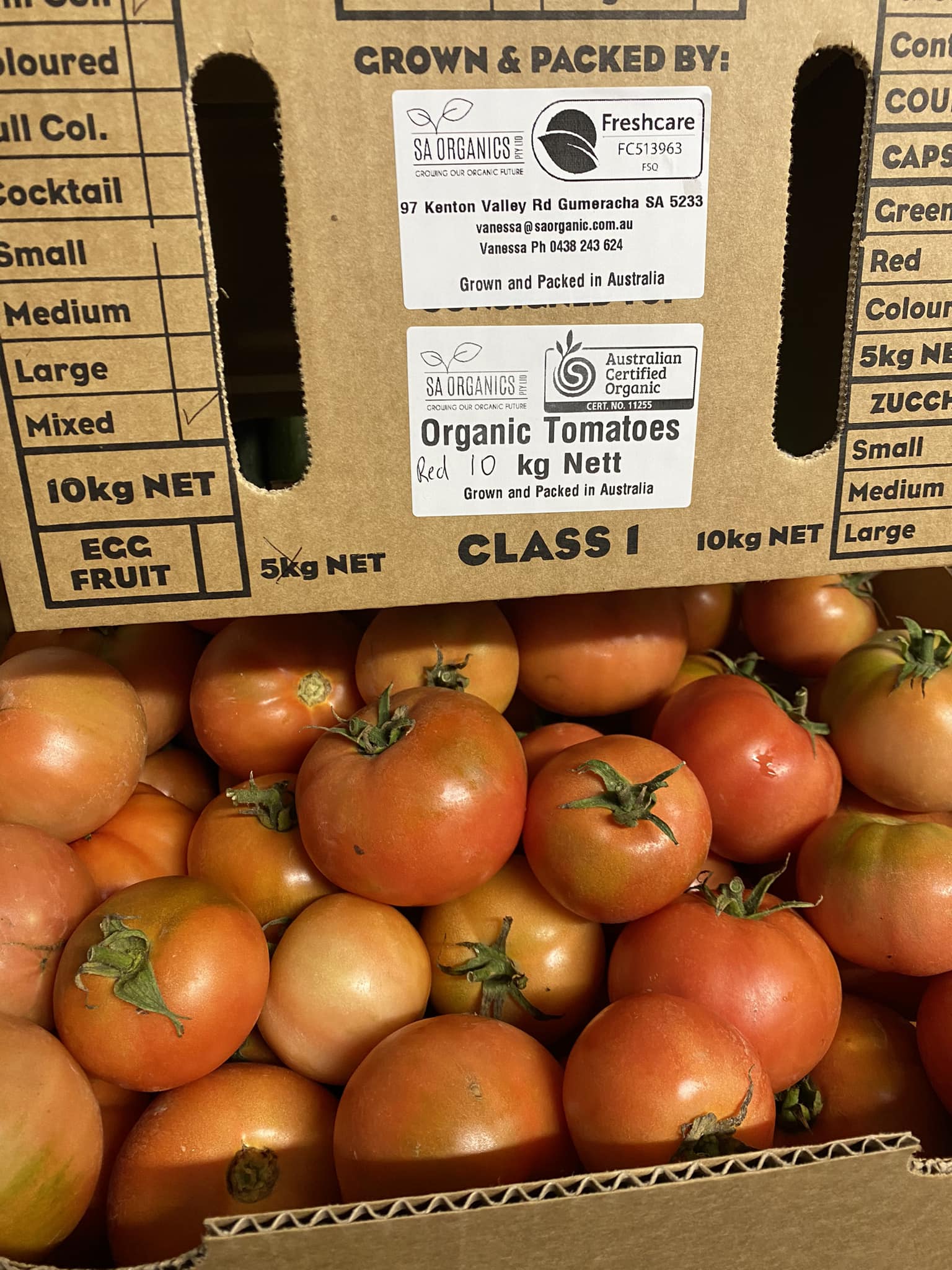 box of organic red tomatoes